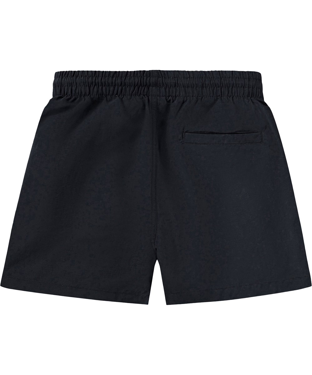 Niko Solid - Black - Black, sporty swim shorts for children made of recycled nylon with UV protection 50+.