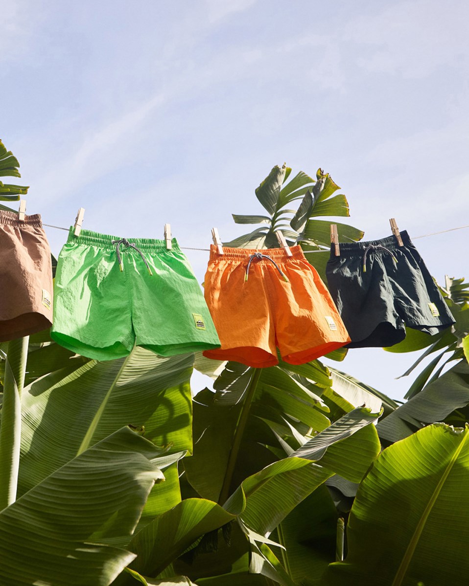 Niko Solid - Wood Green - Sporty dark green swim shorts for active children in recycled nylon with UV protection 50+.