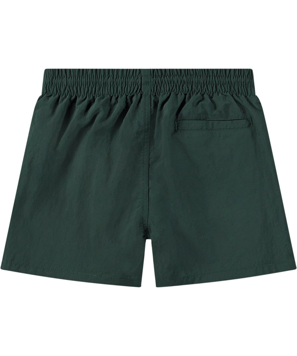 Niko Solid - Wood Green - Sporty dark green swim shorts for active children in recycled nylon with UV protection 50+.