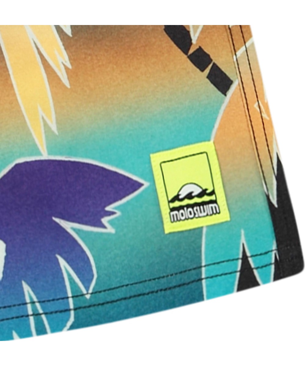 Nilson - Faded Palmtrees - Knee-length swim shorts for active children in recycled polyester with UV protection 50+.