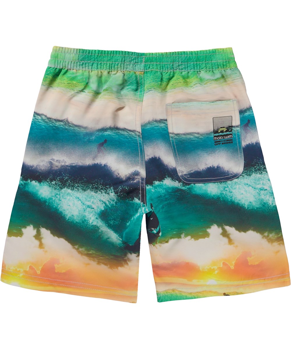 Nilson Glowing Surf Swim shorts with a print of waves and surfers