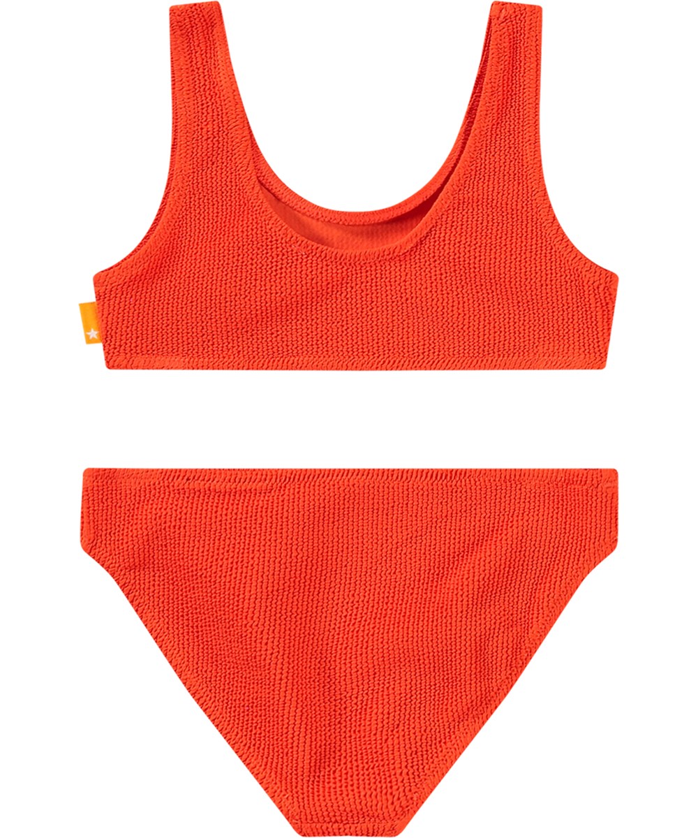Nola Solid - Strawberry Hot - Stretchable red bikini for children in textured pattern with UV protection 50+.