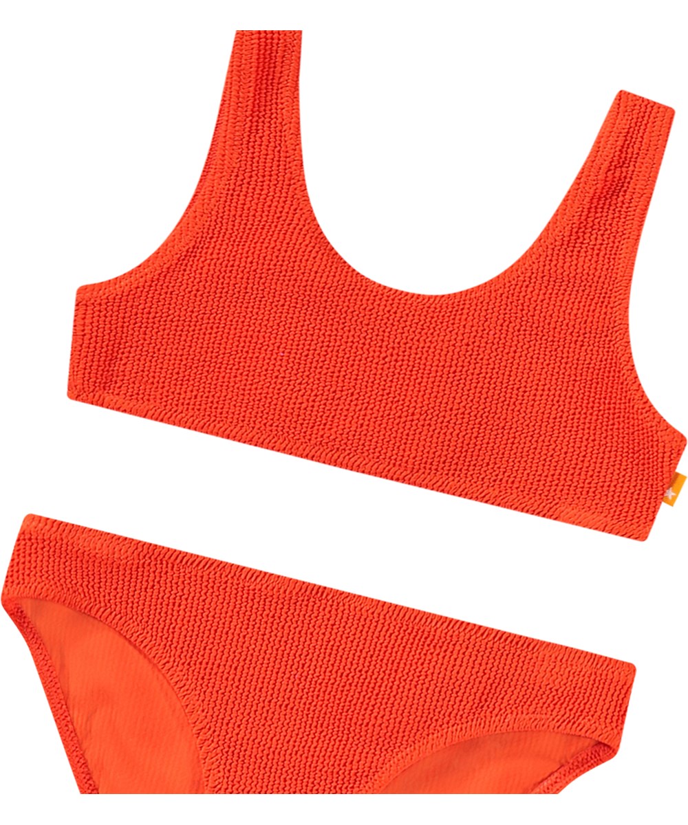 Nola Solid - Strawberry Hot - Stretchable red bikini for children in textured pattern with UV protection 50+.