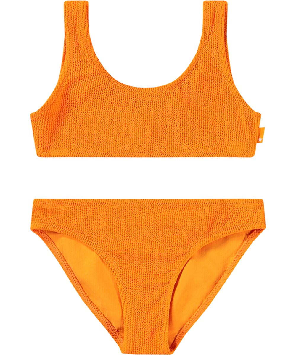 Nola Solid - Tumeric - Stretchable orange bikini for children in textured pattern with UV protection 50+.