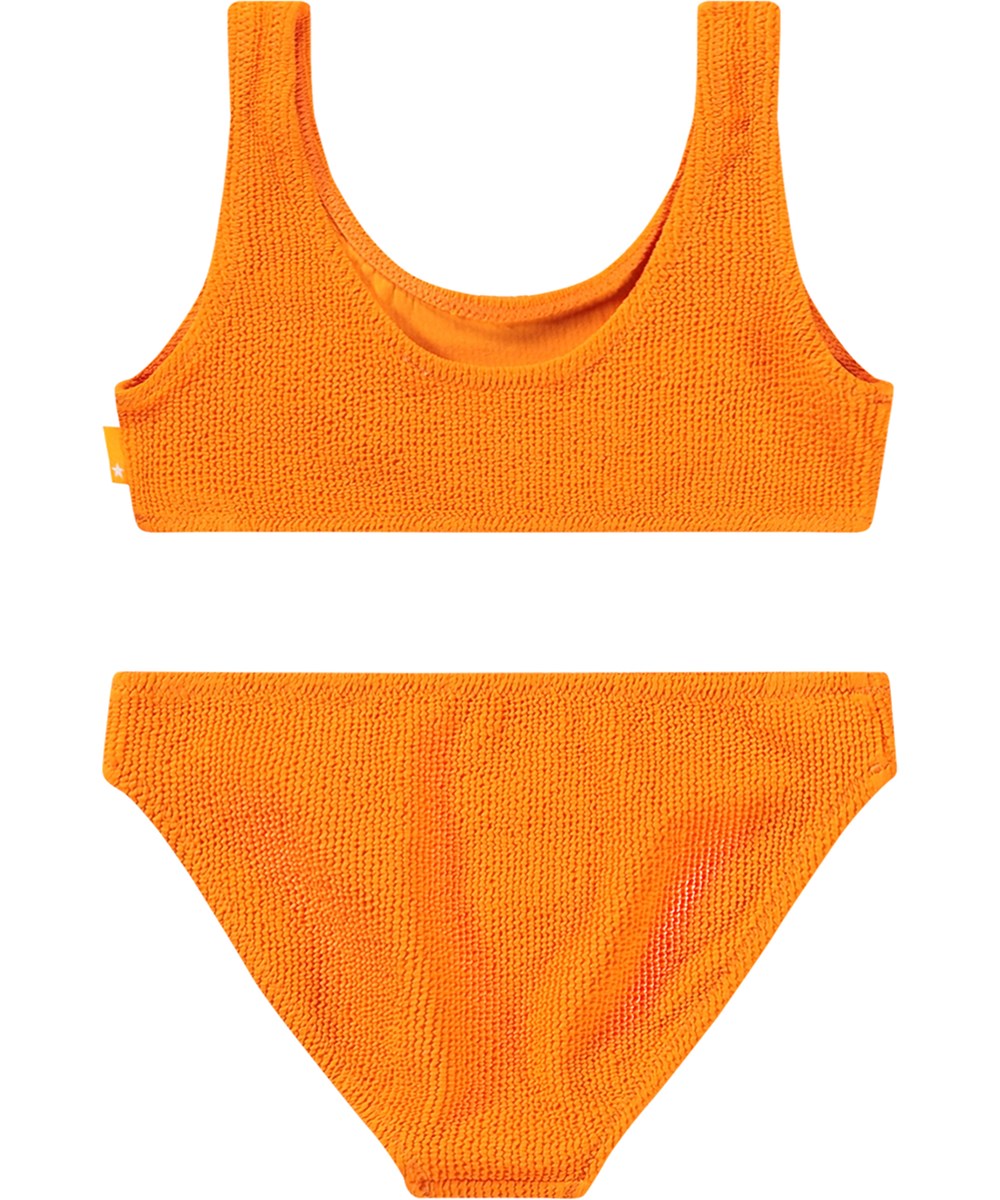 Nola Solid - Tumeric - Stretchable orange bikini for children in textured pattern with UV protection 50+.