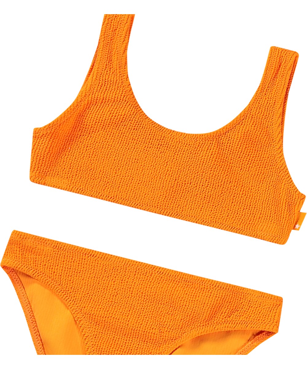 Nola Solid - Tumeric - Stretchable orange bikini for children in textured pattern with UV protection 50+.