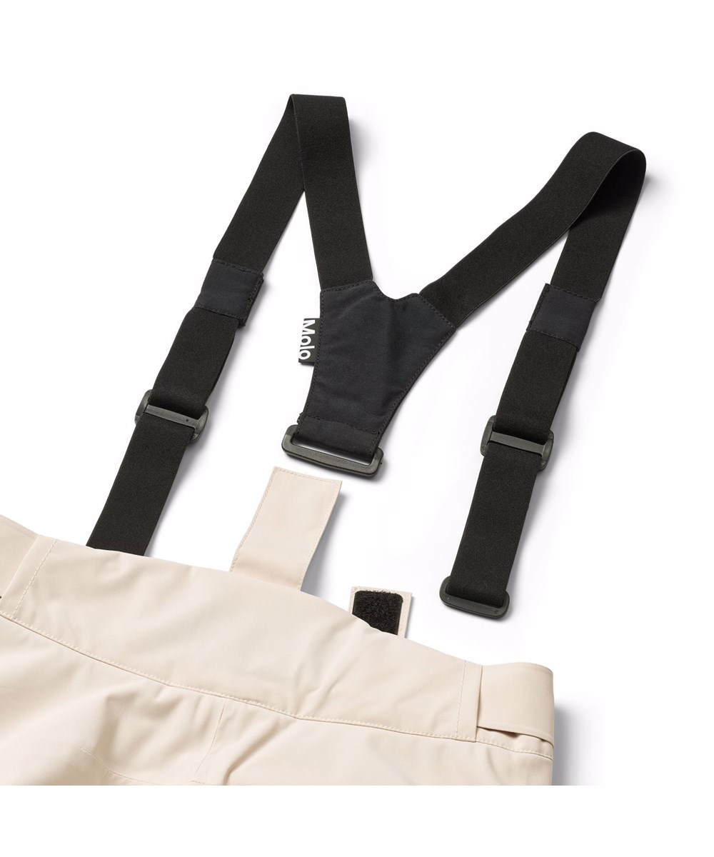 Jump Pro - Vanilla - Off-whitea vind- och vattentäta skidbyxor för barn tillverkade av återvunnen polyester och vadderade med 3M™ Thinsulate™.