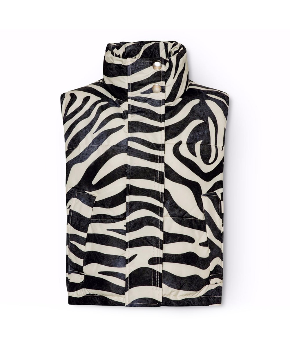 Halfrida - Zebra - Vadderad väst för barn med zebrarandigt mönster tillverkad av återvunnen polyester.